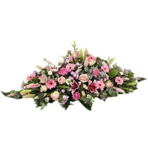 Mireille - Raquette de deuil en fleurs dans les tons de rose.